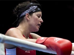 Canada's Mary Spencer returns to her corner after losing 17-14 against China's Jinzi Li during their 68-75kg women's quarterfinal bout at the 2012 Summer Olympics on August 6, 2012 in London.Spencer and Ariane Fortin's Olympic dreams both ended in heartbreak; Spencer eliminated in her opening bout in London, Fortin failing to make the team altogether. (Ryan Remiorz/The Canadian Press)