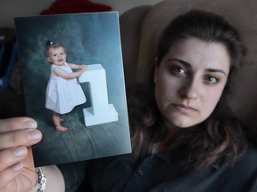 Windsor resident Katelynn Smith, 24, holds one of her few remaining images of her late daughter Jocelynn. Most of Smith's digital pictures of Jocelynn were lost when someone stole Smith's purse out of her vehicle. (Dan Janisse / The Windsor Star)