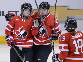 Team Canada's Marie-Philip Poulin, left, celebrates her first period goal with teammates Natalie Spooner, centre, and Brianne Jenner against Team Switzerland during the IIHF Women's World Hockey Championship in Ottawa Wednesday April 3, 2013. (THE CANADIAN PRESS/Sean Kilpatrick)