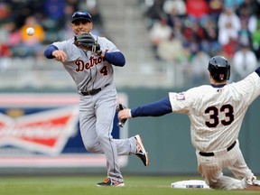 Minnesota's Justin Morneau, right, is thrown out at second base as Detroit's Omar Infante looks to turn a double play April 3, 2013 at Target Field in Minneapolis. (Hannah Foslien/Getty Images)