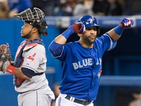 Toronto's Jose Bautista, right, celebrates in front of Cleveland's Carlos Santana after hitting a two-run homer in Toronto Thursday, April 4, 2013. (THE CANADIAN PRESS/Chris Young)