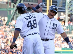 Detroit's Miguel Cabrera, right, celebrates hits a two-run homer with teammate Torii Hunter during the first inning against the Minnesota Twins at Comerica Park April 30, 2013 in Detroit. (Leon Halip/Getty Images)