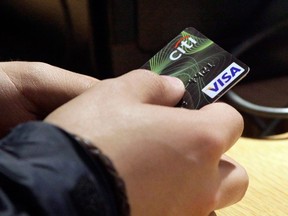 A Visa credit card is used at in this May 9, 2012 file photo. (Canadian Press files)