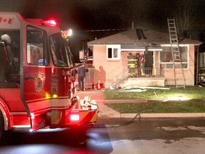 Fire officials attend the scene of a fire at a home in the 1200 block of Westcott Road in Windsor on Friday, April 26, 2013. (REBECCA WRIGHT/ The Windsor Star)