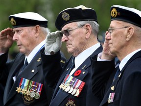 Files: World War II veterans of the Battle of the Atlantic, Robert Elford, left, Larry Costello and Bob Aitken salute during the Battle of the Atlantic Commemoration Service held at Dieppe Gardens May 2, 2010, in Windsor,