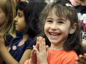 Giles Campus French Immersion Public School student Nareeman Al-Chalabi, right, claps along with songs during Fill the Skies with Music May 6, 2013. (NICK BRANCACCIO/The Windsor Star)