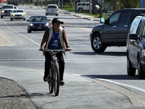 Migrant worker Anselmo Chali of Guatemala, pedals along Hwy. 77 in Leamington, not far from where a migrant worker was hit by an alleged drunk driver on Road 4,  May 6, 2013. (NICK BRANCACCIO/The Windsor Star)