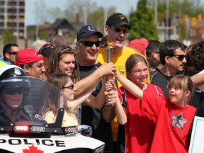 Windsor Police Chief Al Frederick had plenty of help from Special Olympics athletes as the torch was carried during annual Troy Klyn Memorial Torch Run benefiting Special Olympics Tuesday May 7, 2013. (NICK BRANCACCIO/The Windsor Star)