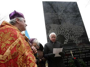 Rev. Pawel Berezniak, left, listens as Peter Mycak reads a proclamation from Ukrainian president Viktor Yushchenko during a service in Jackson Park in Windsor on Sunday, Nov. 19, 2006. (Windsor Star files)