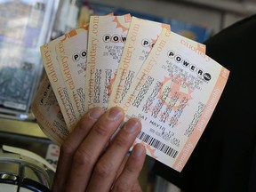 A customer holds $140 worth of Powerball tickets that he purchased on May 17, 2013 in San Francisco, Calif. Some lucky person walked into a Publix supermarket in Zephyrhills, Fla., over the past few days and bought a ticket now worth an estimated US$590.5 million — the highest Powerball jackpot in history ‑ and worth 12 times the annual budget for the city in which it was purchased.
(Justin Sullivan/Getty Images)