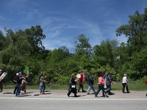 In this file photo, demonstrators march along Matchette Road in front of the Ojibway Nature Centre protesting plans to build big box stores close to Ojibway Park, Saturday, May 25, 2013. (DAX MELMER/The Windsor Star)