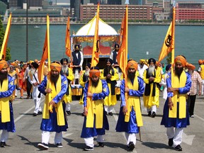 Local Sikhs join a parade to celebrate Khalsa Day at the Riverfront Festival Plaza in downtown Windsor, Sunday, May 19, 2013.  (DAX MELMER/The Windsor Star)