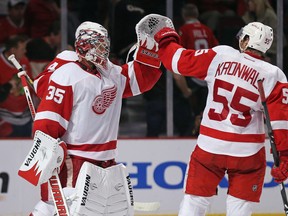 Jimmy Howard, left, of the Detroit Red Wings celebrates a win with teammate Niklas Kronwall over the Chicago Blackhawks in Game 2 of the Western Conference Semifinals at the United Center on Saturday, May 18, 2013 in Chicago. The Red Wings won 4-1. (Jonathan Daniel/Getty Images)
