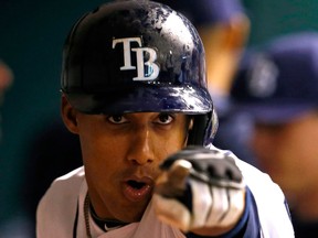 Tampa Bay's Yunel Escobar points to a TV camera after his solo home run during the seventh inning against the Toronto Blue Jays. (AP Photo/Mike Carlson)