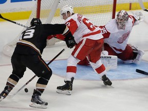 Anaheim's Nick Bonino, left, scores the winning goal past Detroit's Joakim Andersson and goalie Jimmy Howard during overtime in Game 5 of their playoff series in Anaheim. (AP Photo/Chris Carlson)