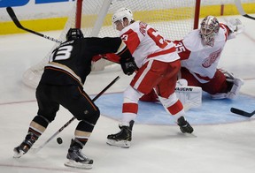 Anaheim's Nick Bonino, left, scores the winning goal past Detroit's Joakim Andersson and goalie Jimmy Howard during overtime in Game 5 of their playoff series in Anaheim. (AP Photo/Chris Carlson)