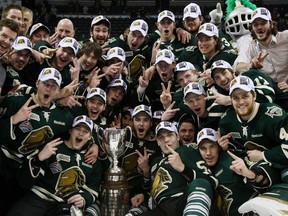 The London Knights surround the Ontario Hockey League Championship trophy after beating the Barrie Colts in Game 7 Monday. (THE CANADIAN PRESS/Dave Chidley)