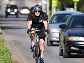Windsor Police Sgt. Matthew D'Asti cautiously pedals his bike in East Windsor Wednesday May 15, 2013. (NICK BRANCACCIO/The Windsor Star)