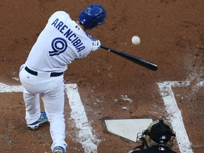 Toronto's J.P. Arencibia hits a run-scoring liner  that was misplayed for an error by Angel Pagan of the Giants at Rogers Centre. (Photo by Tom Szczerbowski/Getty Images)