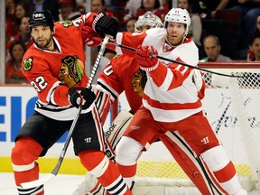 Detroit's Daniel Cleary, right, battles with Chicago's Michal Rozsival in Game 1 of the Western Conference semifinal in Chicago Wednesday. (AP Photo/Nam Y. Huh)