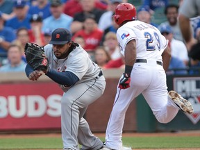 Detroit's Prince Fielder, left, makes the catch for the out on Adrian Beltre of the Rangers in the first inning at Rangers Ballpark in Arlington. (Photo by Rick Yeatts/Getty Images)