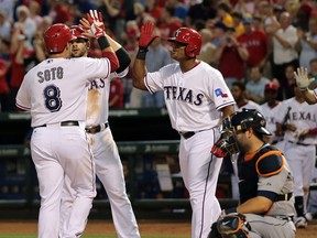 Detroit catcher Alex Avila, right, looks on as Geovany Soto congratulated by Mitch Moreland and Adrian Beltre of the Texas Rangers. (Photo by Rick Yeatts/Getty Images)