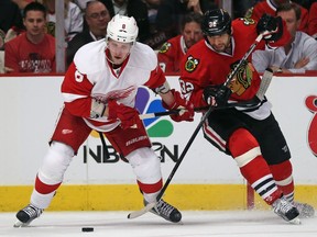 Detroit's Justin Abdelkader, left, is checked by Chicago's Michal Rozsival in Game 1 of the Western Conference semifinal at the United Center in Chicago. (Photo by Jonathan Daniel/Getty Images)