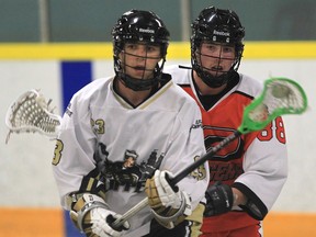 Windsor's Hunter Bushnell, left, battles with Point Edward's Connor Smith at Forest Glade Arena. (JASON KRYK/ The Windsor Star)