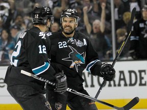 San Jose's Dan Boyle, right, celebrates with Patrick Marleau after scoring a goal against Los Angeles in Game 3 Saturday. (AP Photo/Tony Avelar)