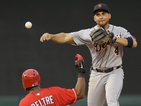 Detroit Tigers second baseman Omar Infante, right, trns a double play against Adrian Beltre of the Texas Rangers during the second inning Saturday in Arlington, Texas. (AP Photo/LM Otero)