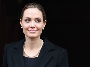 Actress Angelina Jolie reveals in a New York Times op-ed piece published on May 14, 2013 that she underwent a preventative double mastectomy and reconstructive surgery that was completed on April 27, 2013. Jolie noted in the piece that she carries the BRCA1 gene that increases a woman's risk for breast cancer and ovarian cancer. Angelina Jolie's mother, Marcheline Bertrand died from ovarian cancer in 2007 at the age of 56. (Photo by Oli Scarff/Getty Images)