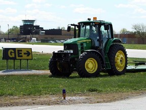 A tractor cuts the grass around the runways and taxi ways at Windsor Airport in Windsor on Monday, May 13, 2013. Cutting the grass is part of a program to reduce bird strikes. Last year the number of bird strikes spiked.                            (TYLER BROWNBRIDGE/The Windsor Star)