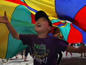A young boy plays underneath a parachute at the City of Windsor's 121st birthday party at the Riverfront Festival Plaza, Monday, May 20, 2013.  (DAX MELMER/The Windsor Star)