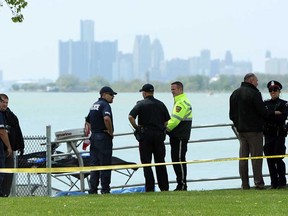 Windsor police investigate after passersby on Riverside Drive East discovered a body in the Detroit River on May 14, 2013. (Tyler Brownbridge / The Windsor Star)