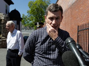 Ruslan Tsarni, right, uncle of killed Boston Marathon bombing suspect Tamerlan Tsarnaev, prepares to speak with reporters in front of the Graham, Putnam, and Mahoney Funeral Parlors, in Worcester, Mass., as funeral director and owner Peter Stefan, left, stands nearby, Sunday, May 5, 2013. Stefan has pleaded for government officials to use their influence to convince a cemetery to bury Tsarnaev, but so far no state or federal authorities have stepped forward. (AP Photo/Steven Senne)