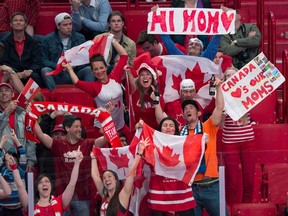 Canadian fans holding Mother's Day signs celebrate as Canada plays the Czech Republic during third-period preliminary round action, Sunday, May 12, 2013 at the world hockey championship in Stockholm, Sweden. (THE CANADIAN PRESS/Jacques Boissinot)