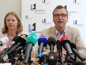 Prosecutor spokespersons Jean-Marc Meilleur, right, and Anja Bijnens address the media in Brussels, Wednesday, May 8, 2013. Police carried out a series of raids in Belgium and detained 31 people in three countries in connection with a spectacular $50 million diamond heist pulled off with apparent clockwork precision at Brussels Airport, a Belgian prosecutor said Wednesday. (AP Photo/Yves Logghe)