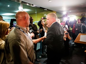 Toronto City Councillor Doug Ford turns away from journalists' questions after reading a statement at Toronto's city hall Wednesday May 22, 2013, as he details how the allegations surrounding his brother, Mayor Rob Ford, have affected his family. THE CANADIAN PRESS/Chris Young