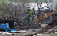 Firefighters sift through the remains of the plastics recycling warehouse at 730 Sprucewood Ave. on May 22, 2013. (Tyler Brownbridge / The Windsor Star)