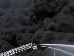 Firefighters battle a blaze at the corner of Ojibway Parkway and Sprucewood Drive in Windsor on Tuesday, May 21, 2013. The fire broke out around 3:30 p.m. and burned into the evening. The fire destroyed a building and contents on the surrounding property.                        (TYLER BROWNBRIDGE/The Windsor Star)