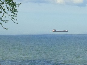This photo from reader Marty Solcz was taken from Sandpoint Beach and shows a freighter seemingly floating above the Detroit River. (Marty Solcz/Special to The Star)
