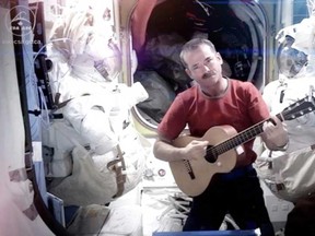 This image provided by NASA shows astronaut Chris Hadfield recording the first music video from space Sunday May 12, 2013. The song was his cover version of David Bowie's Space Oddity. Hadfield and astronaut Thomas Marshburn returned to earth Monday May 13, 2013. (AP Photo/NASA, Chris Hadfield)