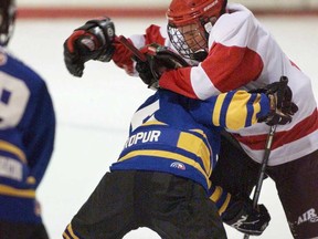 In this file photo, players collide in a peewee game in Halifax. Hockey Alberta has banned peewee bodychecking. (THE CANADIAN PRESS/Andrew Vaughan)