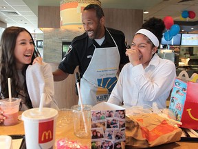 Windsor Police Sgt. Wren Dosant jokes with Assumption students Samantha Enriquez, 14, and Alexus Wilson, 15, at the McDonalds on Huron Church, Wednesday, May 8, 2013, in Windsor, Ont. It was for the annual McHappy Day fundraising event. (DAN JANISSE/The Windsor Star)