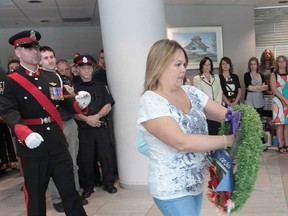 Shelley Atkinson participates in a memorial ceremony Monday, May 6, 2013, for her husband Windsor Police Const. John Atkinson who was killed in the line of duty seven years ago. The ceremony was held at the downtown police headquarters. (DAN JANISSE/The Windsor Star)