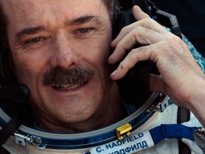 Canadian astronaut Chris Hadfield, speaks on cell phone shortly after the landing of the Russian Soyuz TMA-07 space capsule about 150 km southeast of the Kazakh town of Dzhezkazgan, Tuesday, May 14, 2013. A Soyuz space capsule with a three-man crew returning from a five-month mission to the International Space Station landed safely Tuesday on the steppes of Kazakhstan. (AP Photo/Mikhail Metzel, Pool)