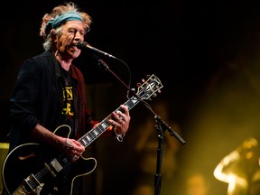 This April 13, 2013 file photo shows Keith Richards performing at Eric Clapton's Crossroads Guitar Festival 2013 at Madison Square Garden in New York. Keith Richards says he doesn't own an iPod.The 69-year-old believes music lovers are “all being short-changed” with the sound that comes out of an iPod, launched in 2001. The Rolling Stones' “50 & Counting Tour” kicks off Friday in Los Angeles. (Photo by Charles Sykes/Invision/AP, file)