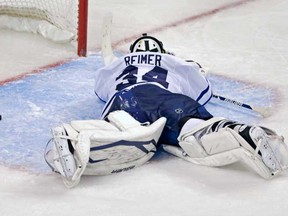 Toronto Maple Leafs goalie James Reimer lays on the ice after getting beat on the game-winning goal by Boston Bruins centre Patrice Bergeron during overtime in Game 7 of their NHL hockey Stanley Cup playoff series in Boston, Monday, May 13, 2013. The Bruins won 5-4. (AP Photo/Charles Krupa)