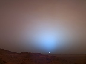 This image taken 19 May 2005 from the Spirit Rover and obtained 03 December 2007 from NASA/JPL shows the sunset casting a blue glow above the rim of Gusev Crater on the planet Mars. (Michael Benson/AFP/Getty Images)