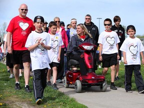 Jodi Tucker, centre, is surrounded by family and friends during the 2013 Mandarin MS Walk near Assumption high school Sunday, May 5 in Windsor, Ont. (KRISTIE PEARCE/The Windsor Star)